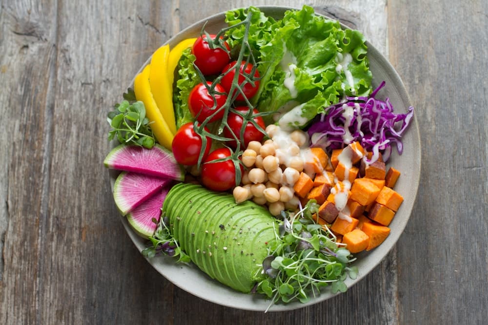 A colourful bowl of fresh vegetables and everyday ingredients